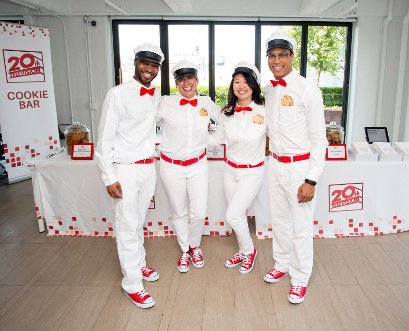 Brand Ambassadors dressed as modern "milk men" while serving milk and cookie shots and assisting employees with filling their cookie bags.