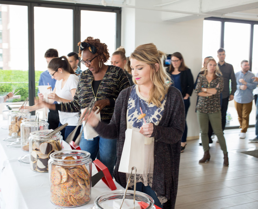 Agency employees enjoy milk and cookie shots while selecting various cookies for their cookie bag at the Twentieth Television Milk & Cookie Bar.