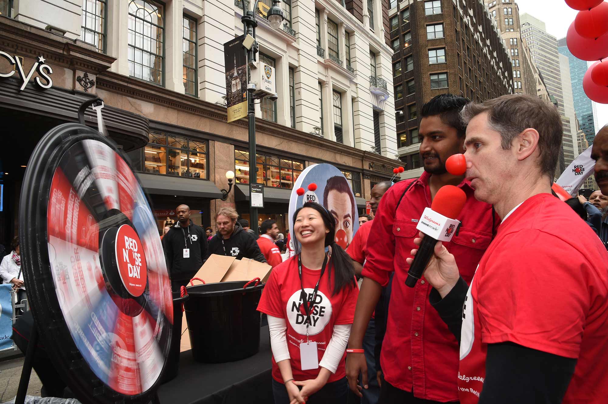 A guest at Duane Reade's Red Nose Day Pre-Event Party anxiously awaits what treat the event prize wheel will land on.