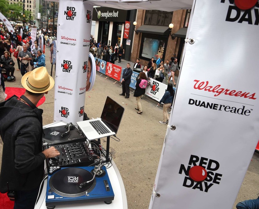 The DJ at Duane Reade's Red Nose Day Pre-Event Party prepares to spin away as guests arrive.