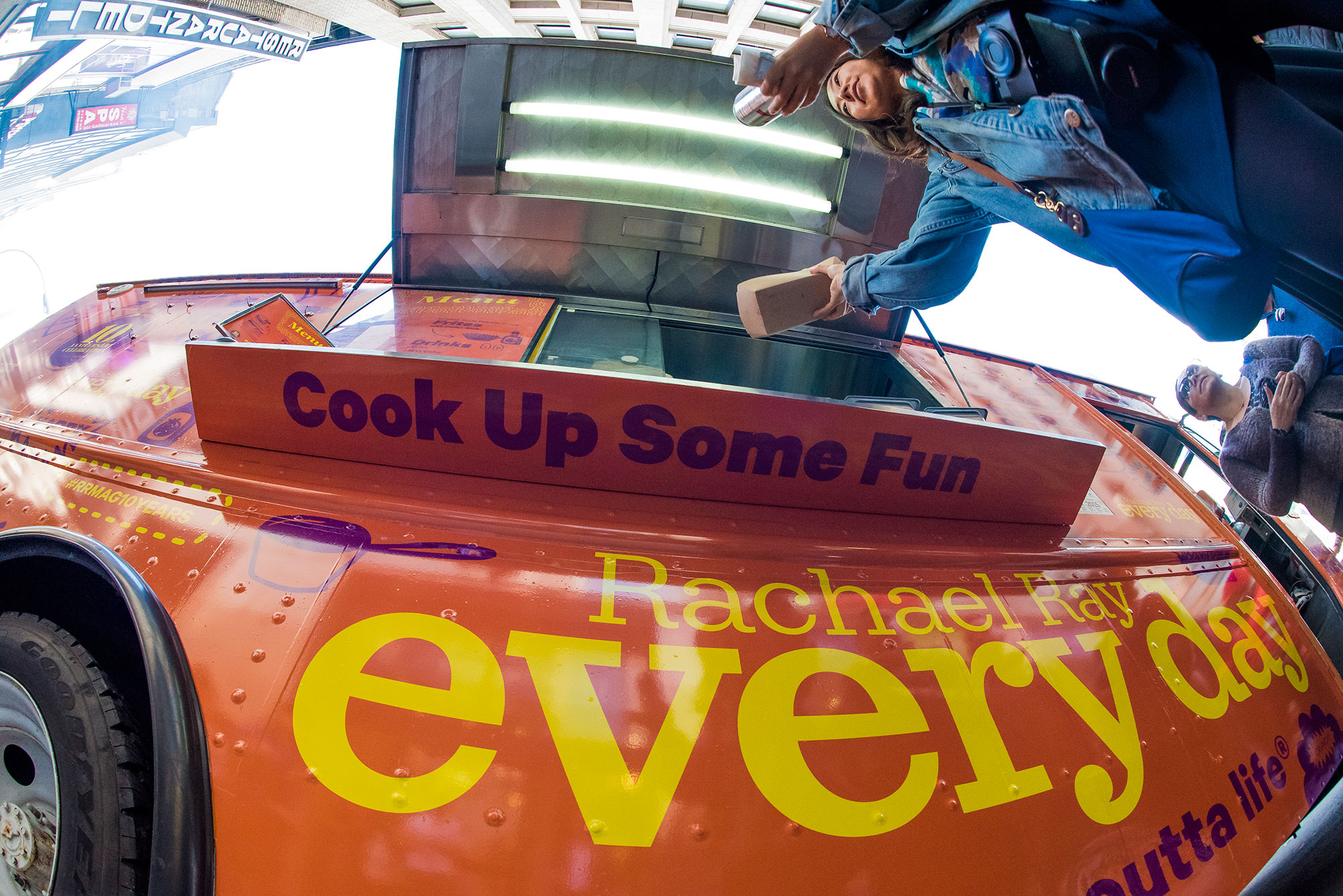 Guests enjoy a free burger from the food truck celebrating 10 years of the magazine, Rachel Ray Every Day.